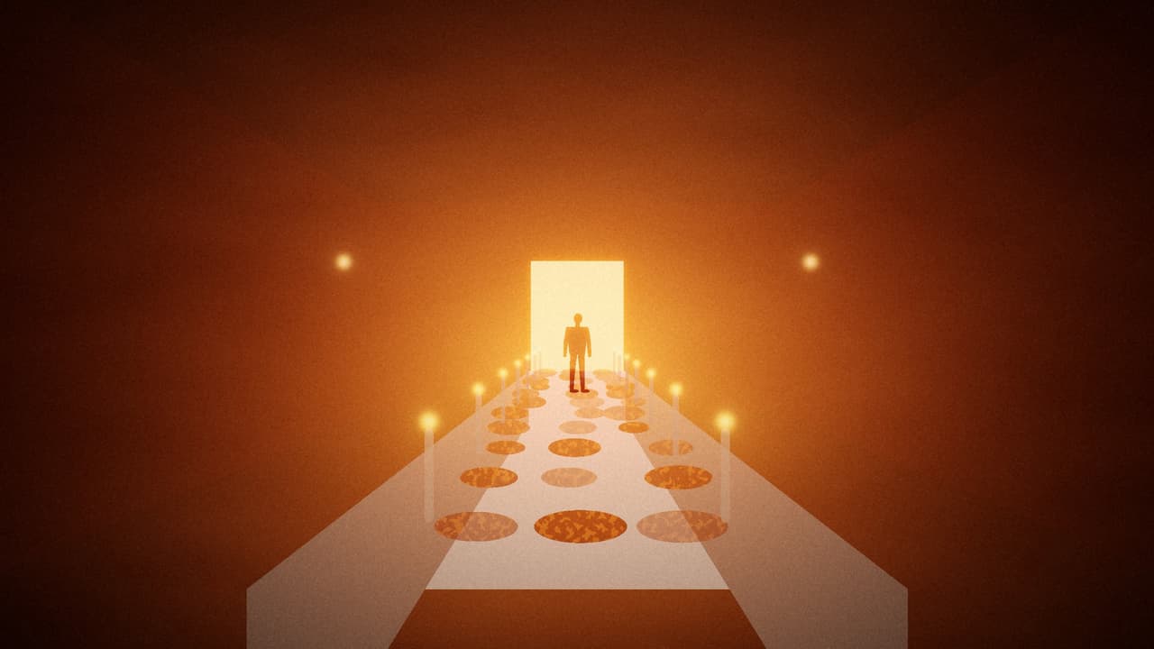A long candle-lit banquet table in a crimson room